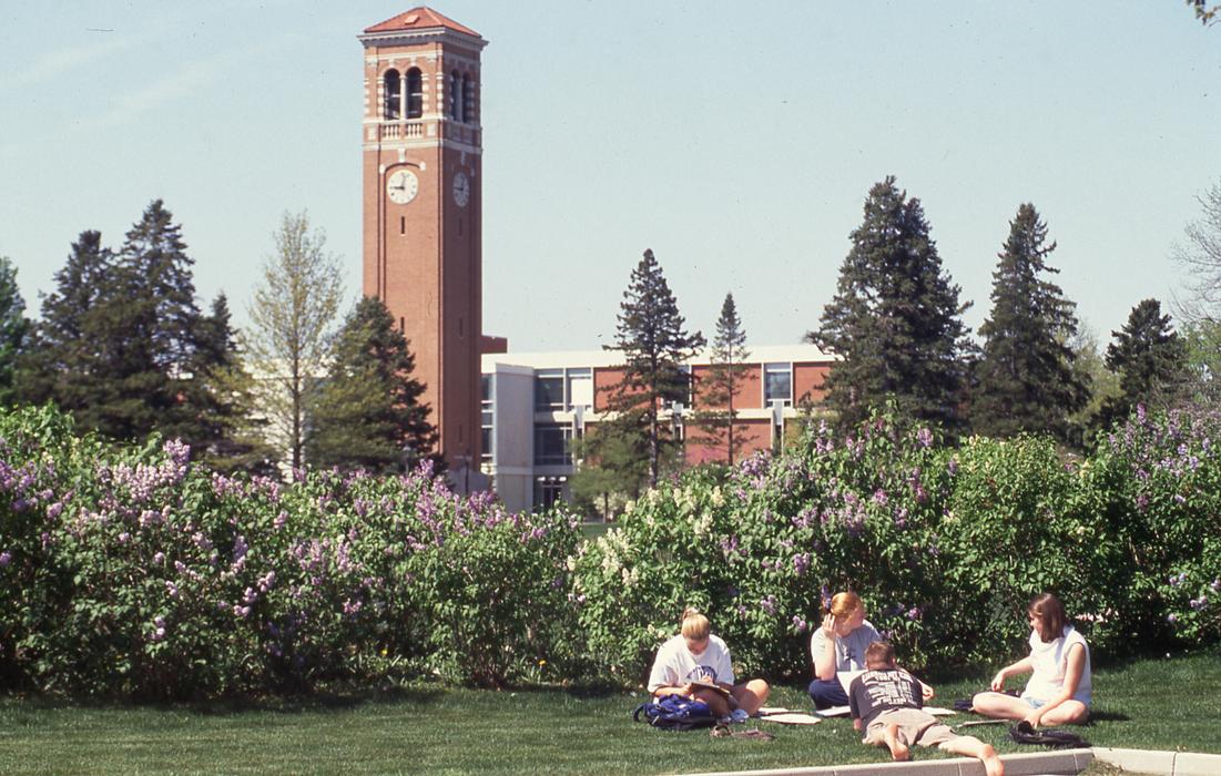 UNI students of the past relaxing in the lawn in front of the Campanile