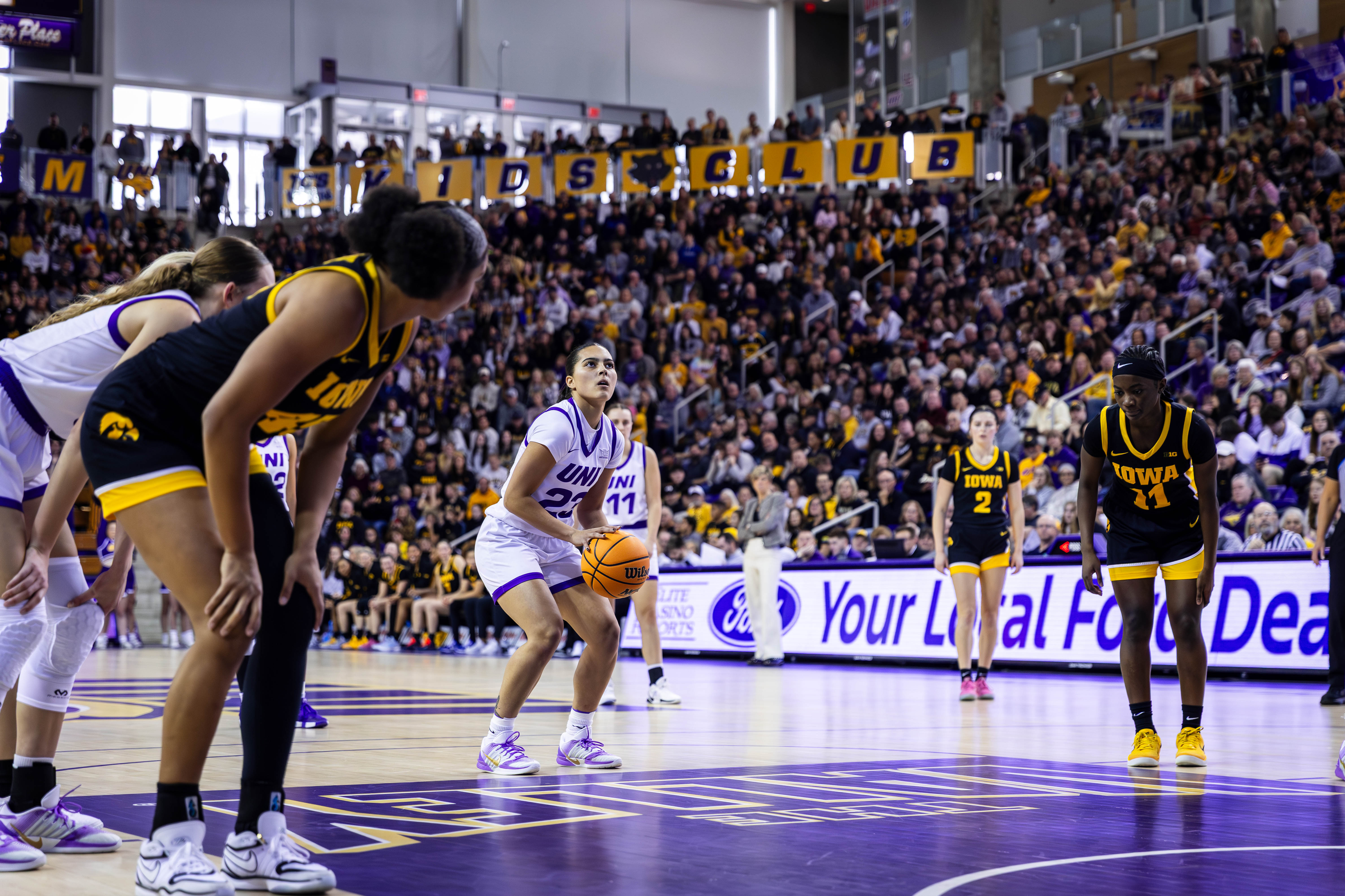 UNI women's basketball athlete taking a shot on the court.