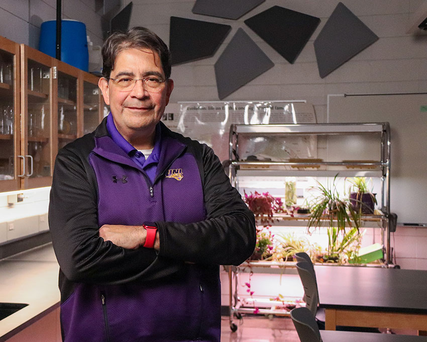 Professor Lawrence Escalada with his arms cross in a Science Education classroom