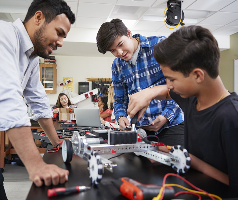 Teacher building simple machines with young students