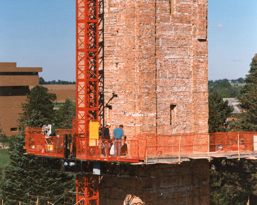 major work being done on the Campanile in 1995-red scaffolding is on the Campanile as a group of workers inspect the upgrades that need to be made