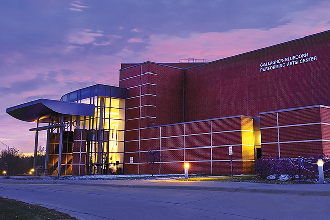 The Gallagher Bluedorn Performing Arts Center exterior with a blue and pink sky