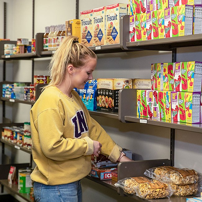 UNI student organizing food at the Panther Pantry