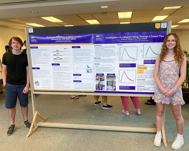 Brother and sister Blaine and Brianna Williams standing next to their undergraduate research project