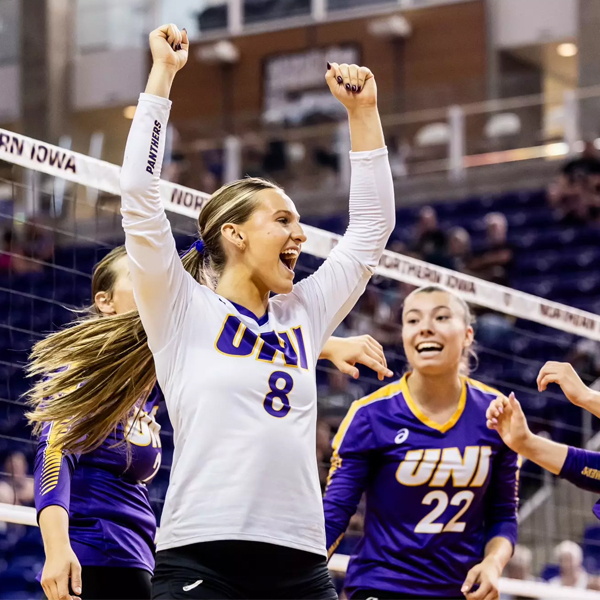 UNI volleyball players celebrate on the court after a point