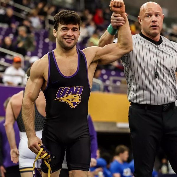 A UNI wrestler is announced the winner following a match in the UNI-Dome